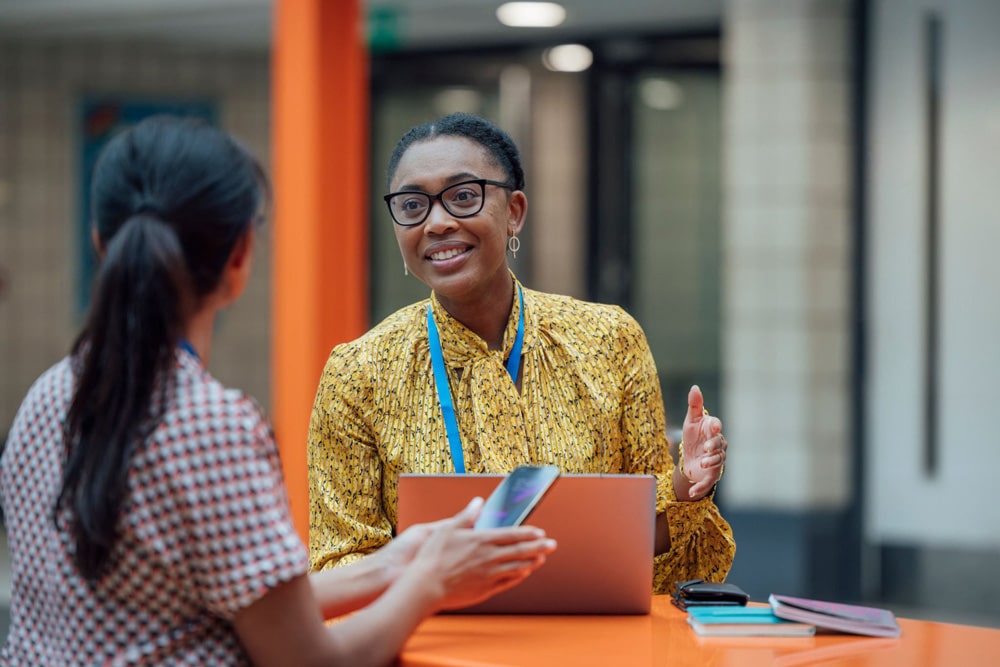 Two-female-teachers-sitting-at-a-table