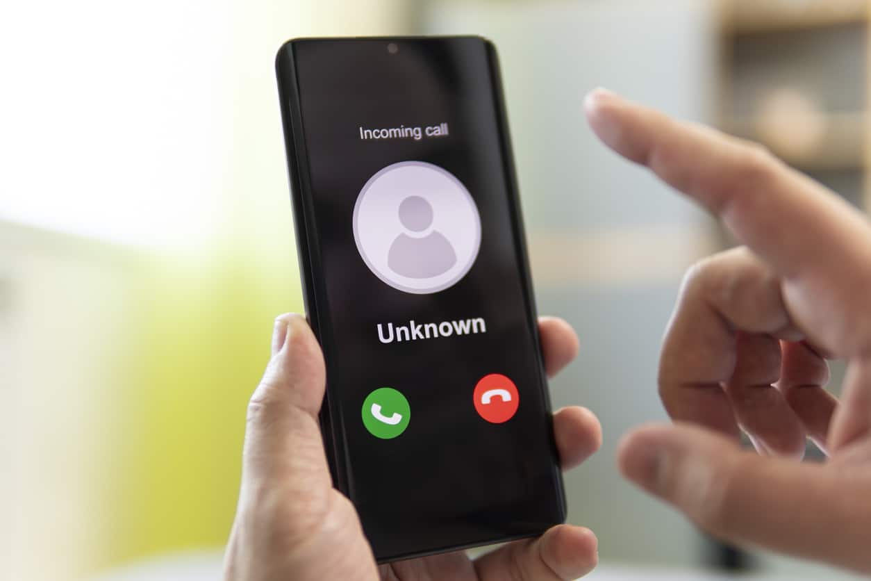 Phone in hand with unknown call coming in